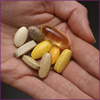 Photo: hand holding dietary supplements