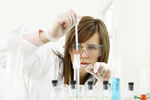 Scientist looking at contents in a test tube